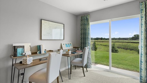Lower level family room has space for desks as well as couches and tv.