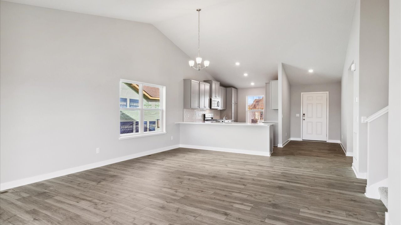 Open main level with vaulted ceilings.