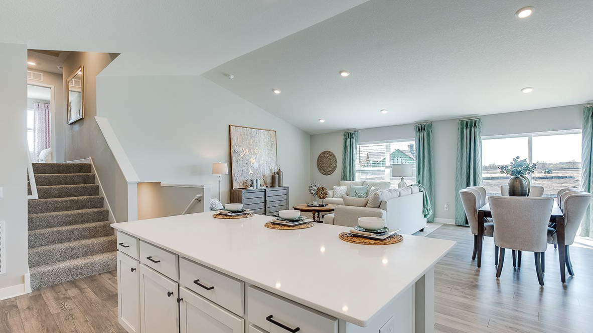 View from kitchen island to living area and outdoor access Amberglen By D.R. Horton