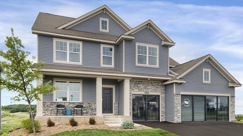 The Whitney model home has a stunning exterior with modern blue siding.
