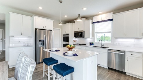 The kitchen of the Jordan plan includes a walkin pantry.