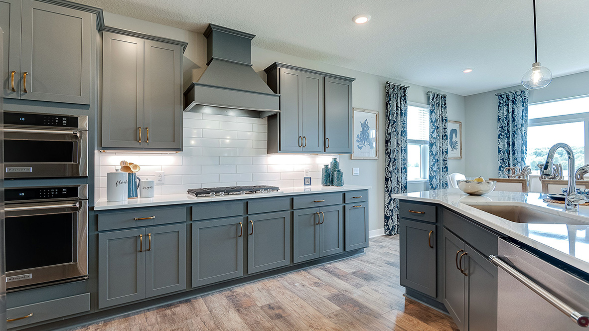 Kitchen with harbor gray cabinets and stainless steel appliances.