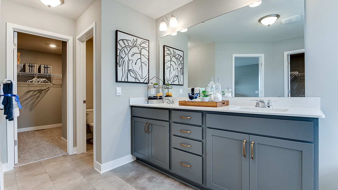 Bedroom suite's private bathroom leading into walk in closet.