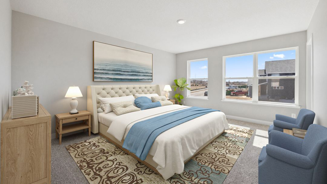 spacious bedroom with beige carpet, light grey walls and windows