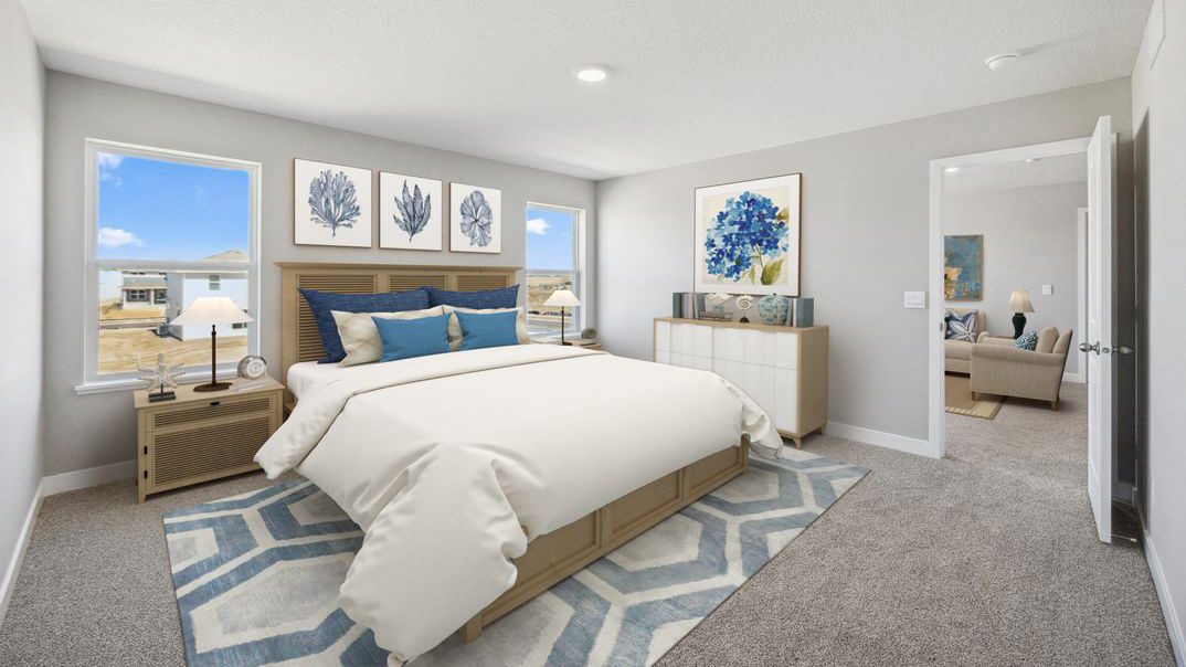 spacious primary bedroom with beige carpet, light grey walls and windows