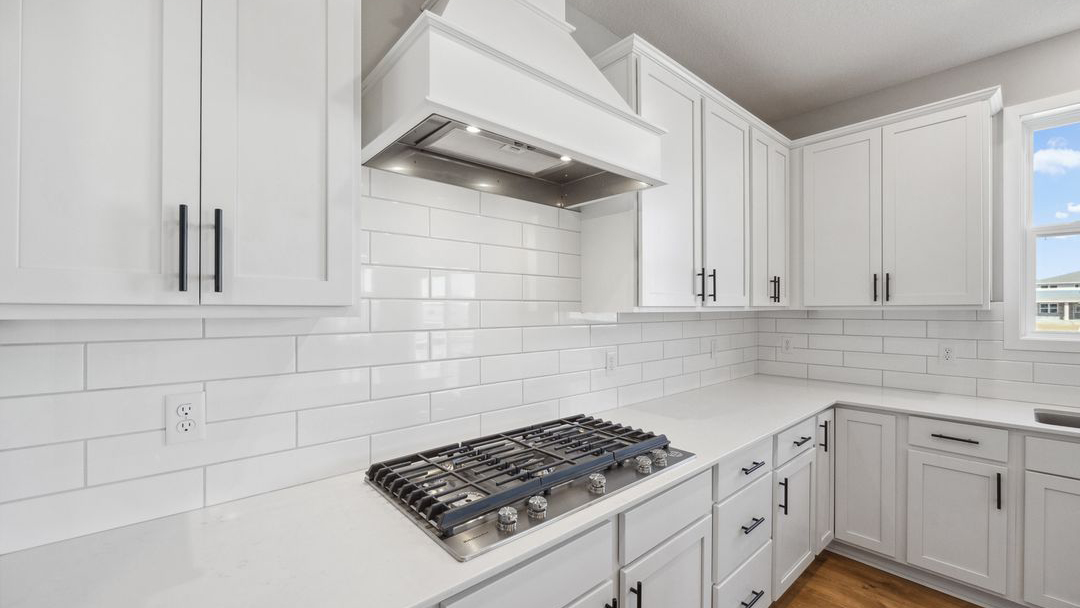 kitchen with white cabinetry and white backsplash