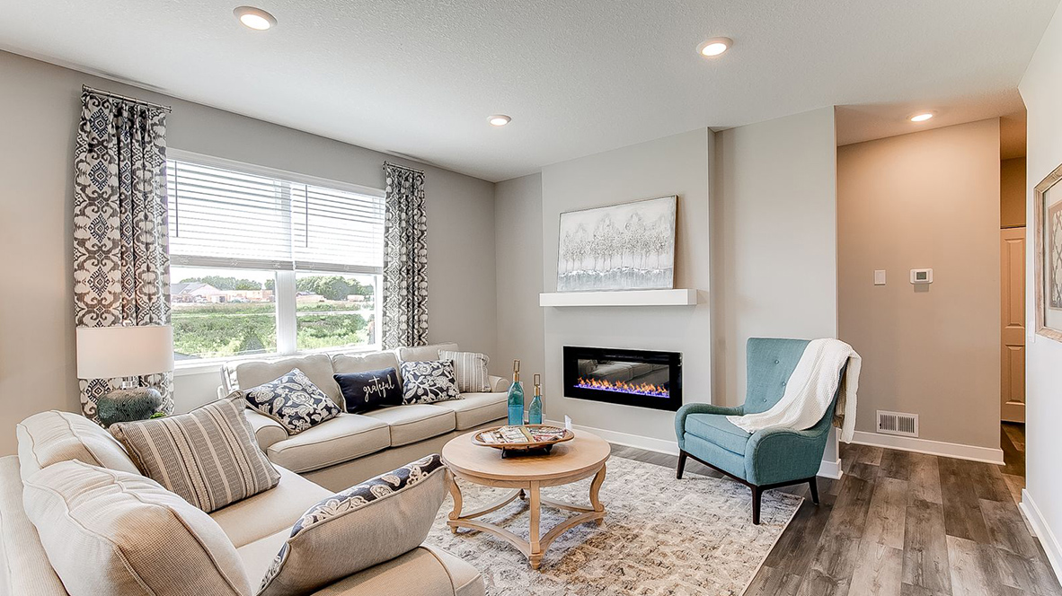 Living room with hard flooring and electric fireplace.