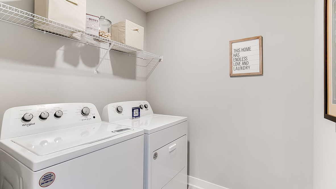 Upper level laundry room with wire shelving unit.