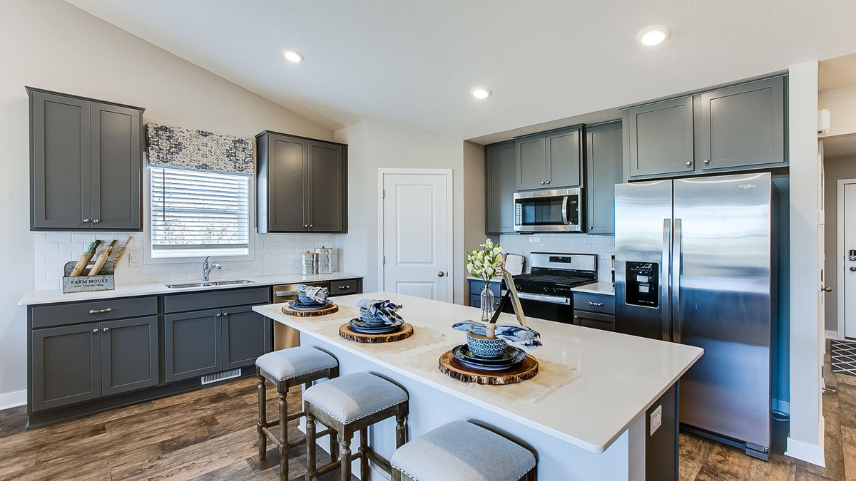 Dark gray cabinets and white quartz countertops in the kitchen.