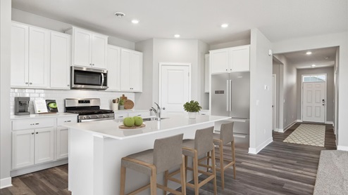 Secondary bathroom with white cabinets and quartz countertop.