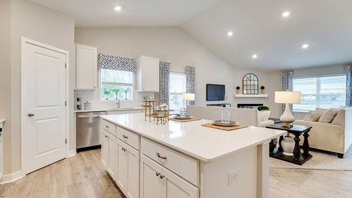 Angled view of kitchen adjacent to living room.