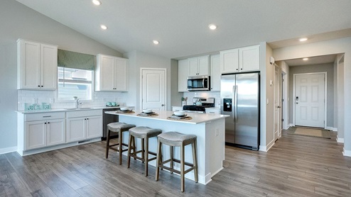 The kitchen is large with an island and breakfast bar.