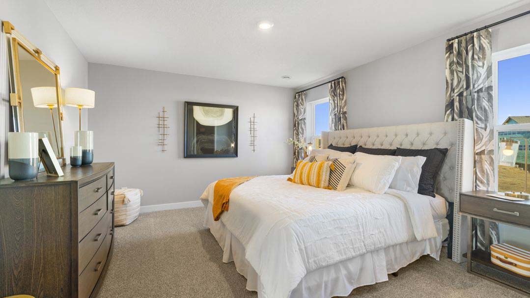 Carpeted bedroom suite with private bathroom and walk in closet.