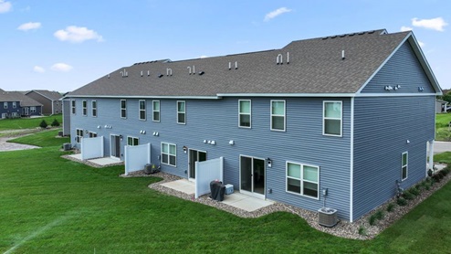 Rear elevation of the townhomes showing the patio.