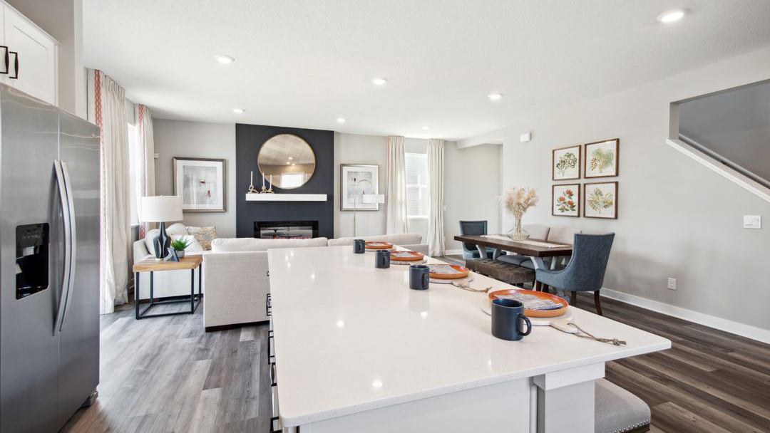 View of open concept main level with kitchen, dinette, and living room.