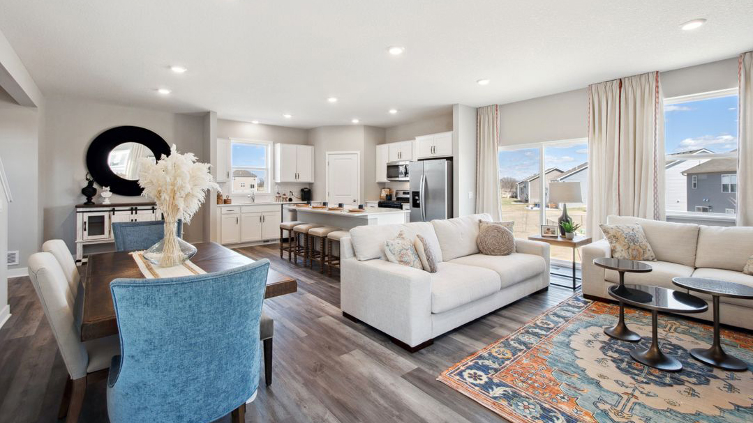 View of open concept main level with kitchen, dinette, and living room.