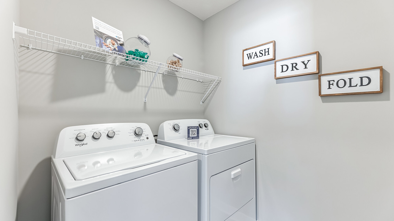 Upper level laundry room with wire shelving unit.