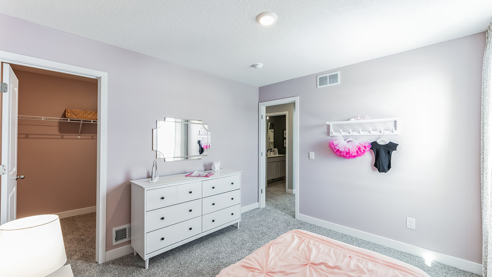 Carpeted secondary bedroom with standard closet.