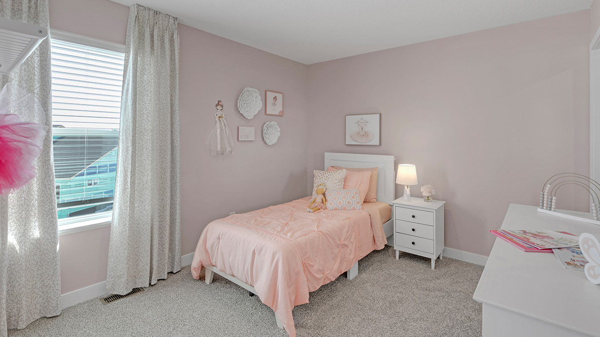 Carpeted secondary bedroom with standard closet.