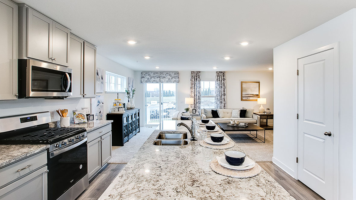 4-person kitchen island with gray cabinets and quartz countertops.