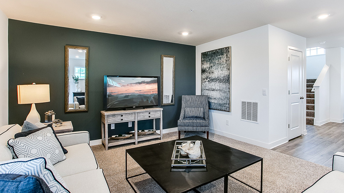 Carpeted living room adjacent to kitchen.