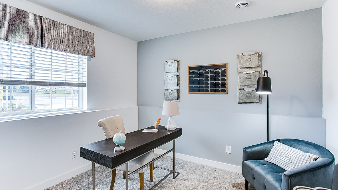 Lower level flex room with a desk and chairs.