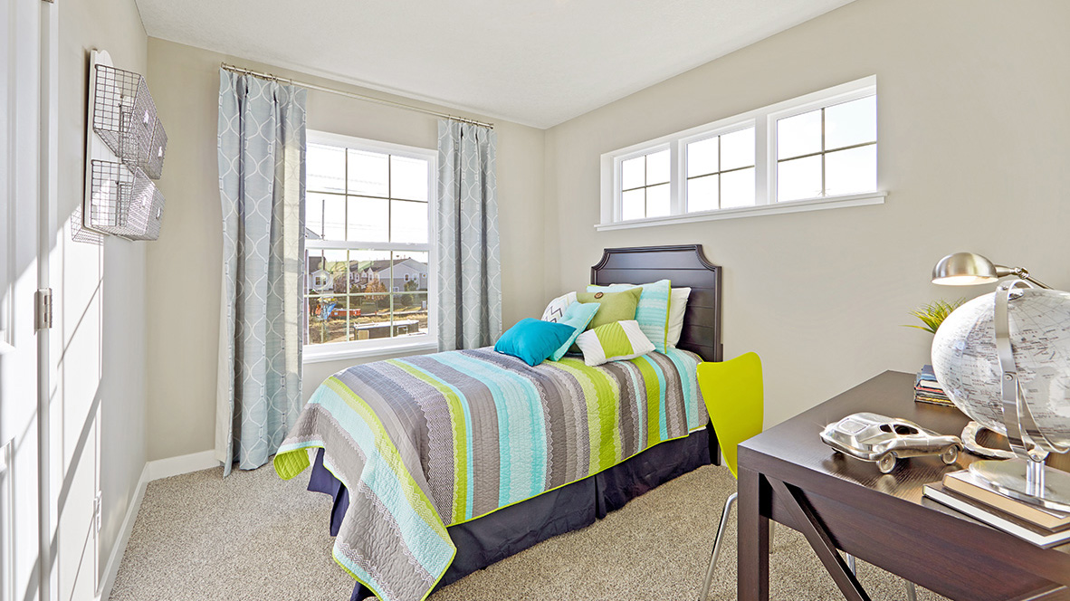 Carpeted secondary bedroom.