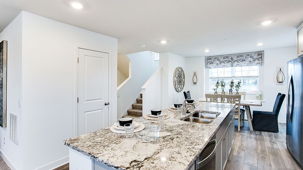 View of kitchen island and dinette areas on open concept main level.