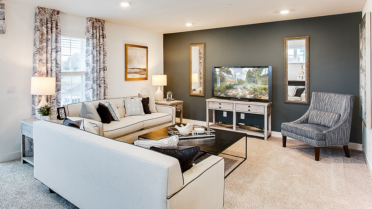 Carpeted living room with electric fireplace.