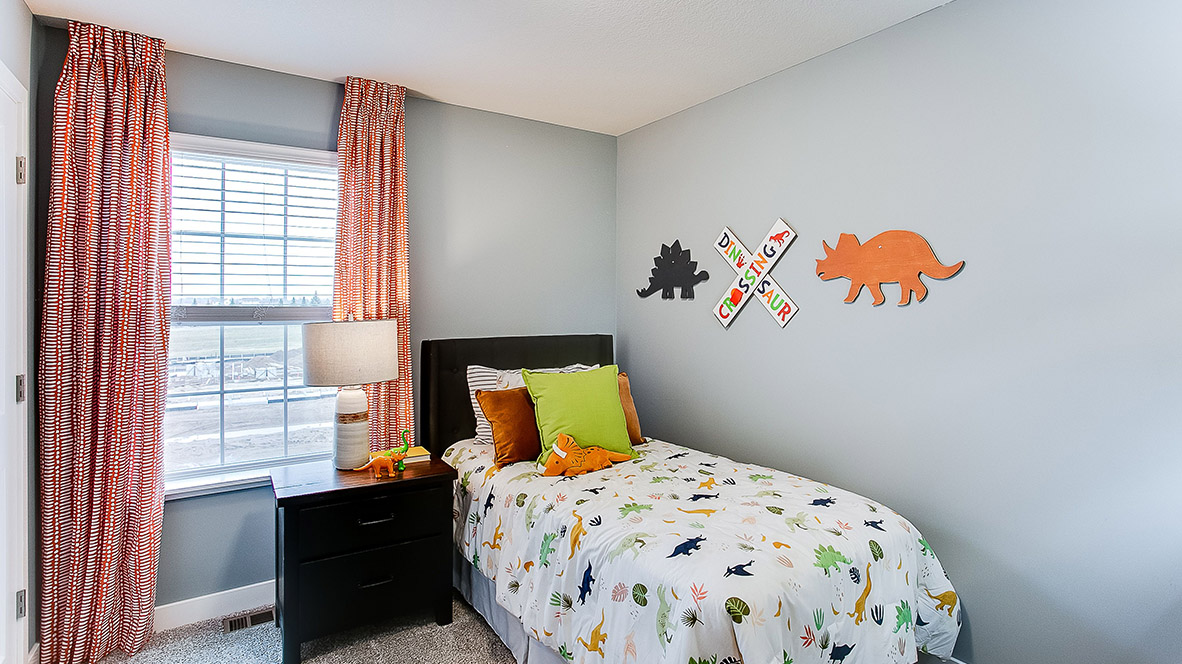 Carpeted secondary bedroom.