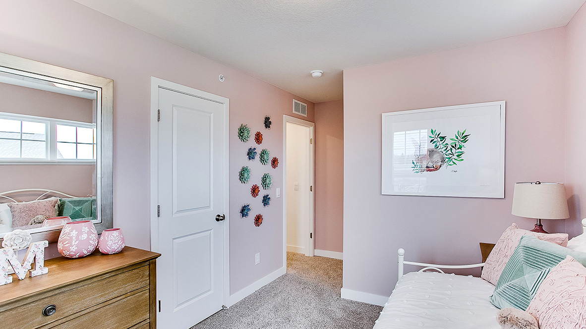 Carpeted secondary bedroom.