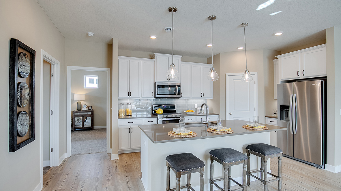 Kitchen in Clifton model home with granite countertops and white cabinets.