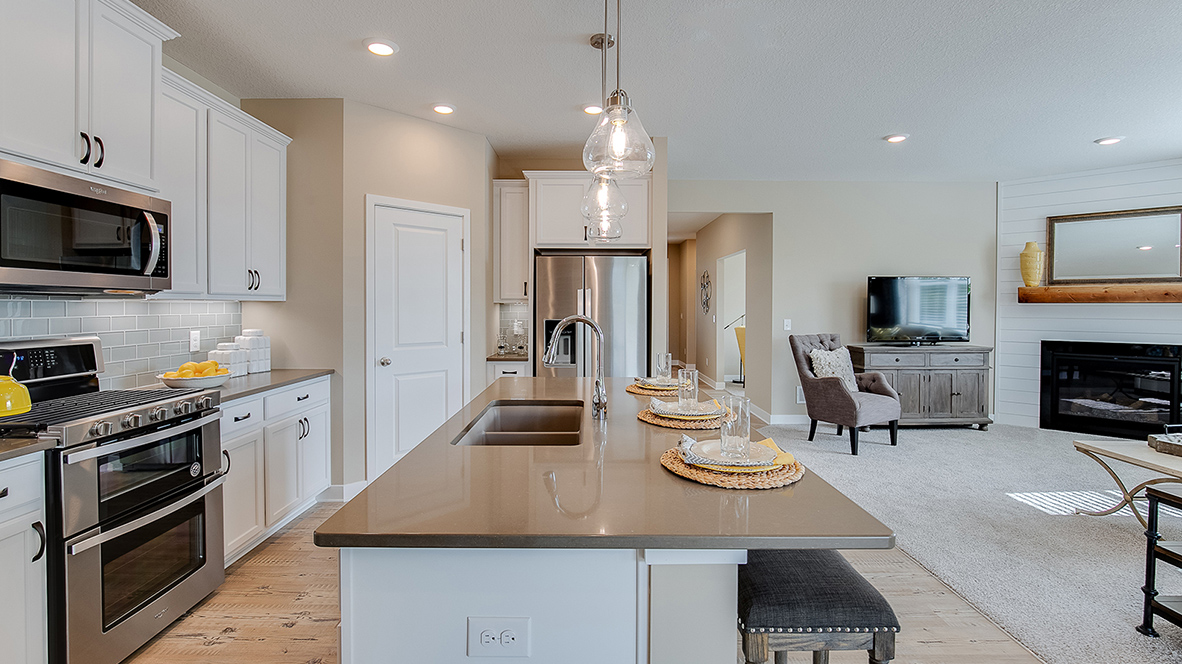 Open concept main level with kitchen adjacent to living room.
