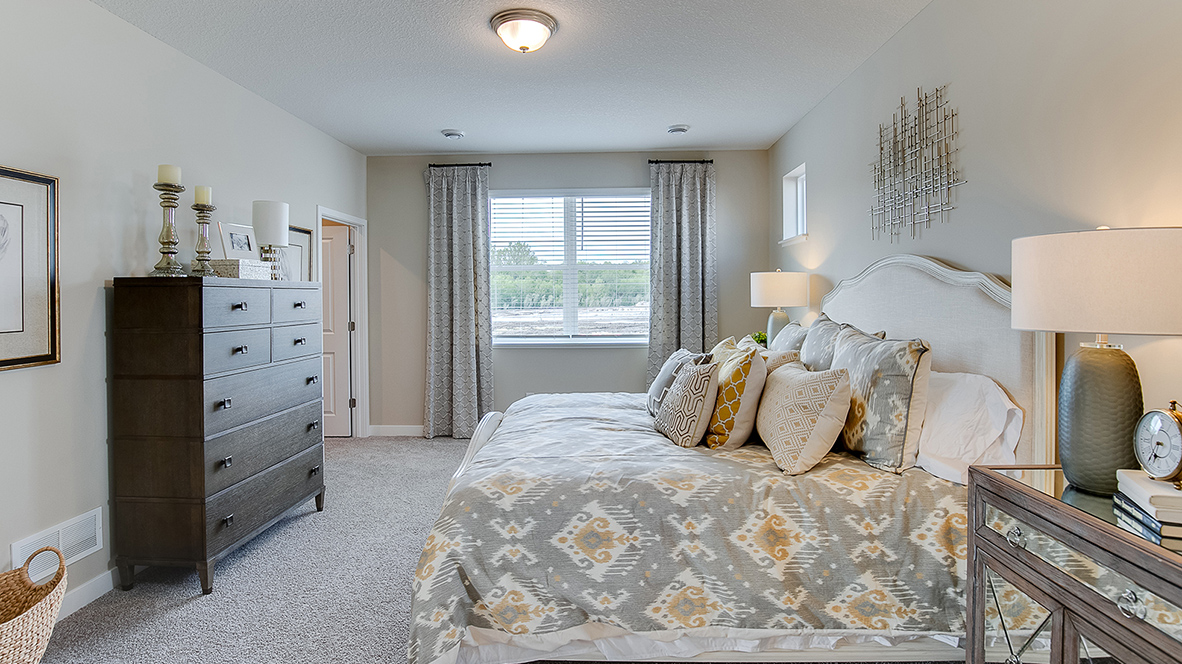 Bedroom suite with dual walk-in closets and private bathroom.