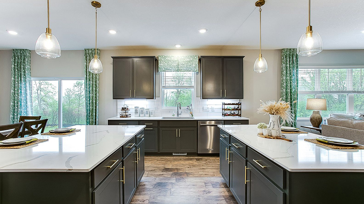 Dual kitchen islands with quartz countertops and pendant lighting.