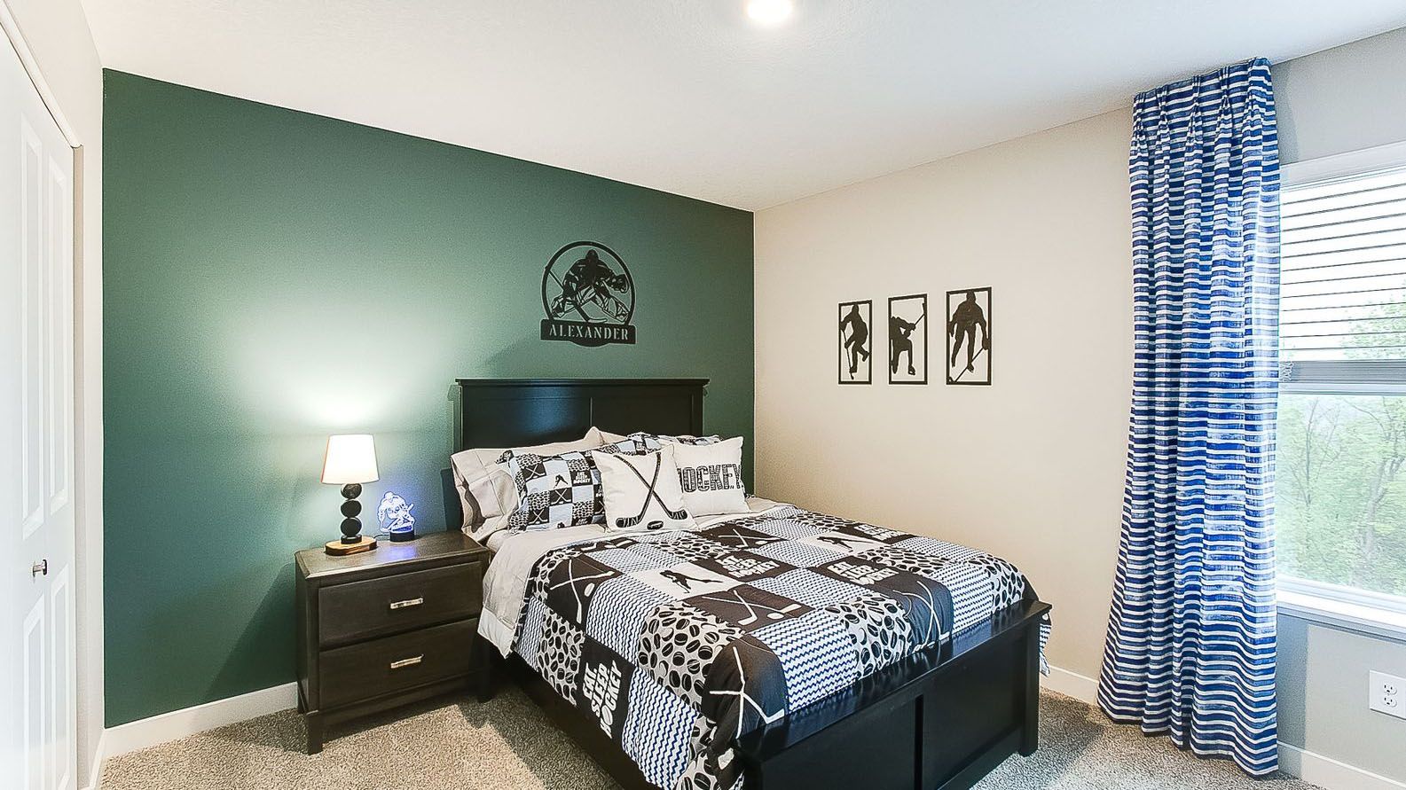 Carpeted secondary bedroom with walk-in closet.