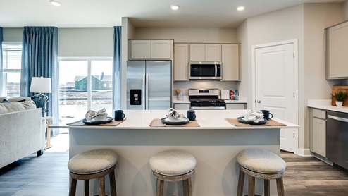 The kitchen features quartz countertops, stainless appliances.