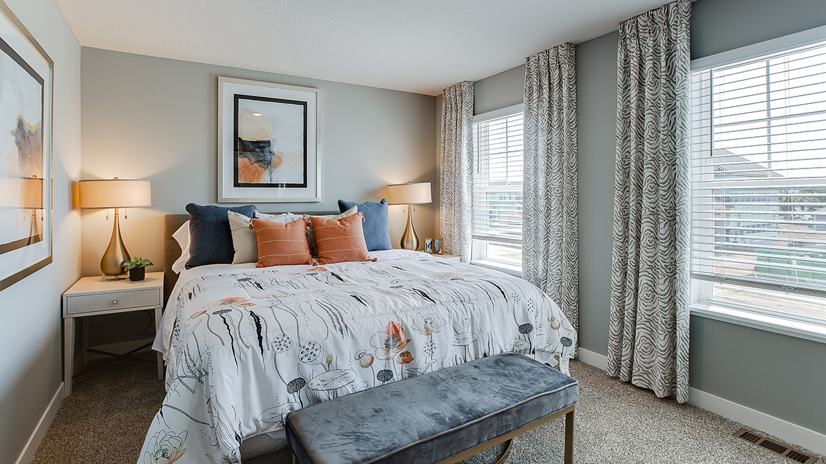 Bedroom suite with dual walk-in closets and private bathroom.