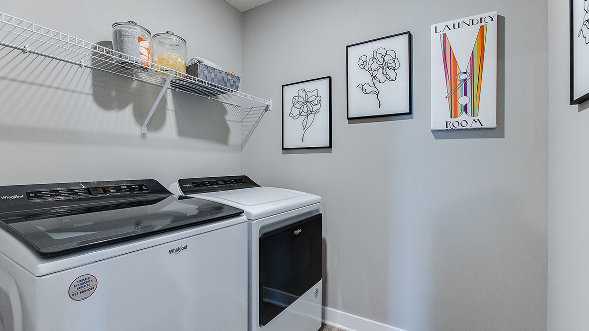 Upper level laundry room with wire shelving unit.
