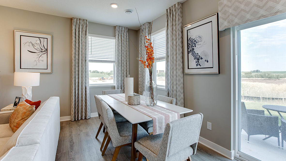 Dinette area staged with 6-person dining room table, adjacent to concrete patio.