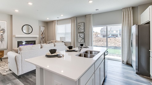 Angled view of kitchen and sliding glass doors leading out to patio.