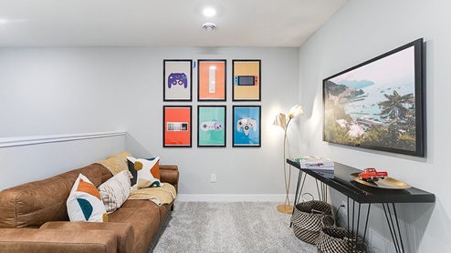 Upper level carpeted loft area with couch and television.