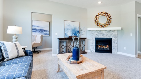 Family room with gas fireplace in the Grant plan.