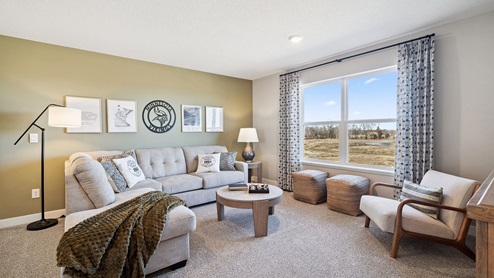 Upper level carpeted loft with living area.