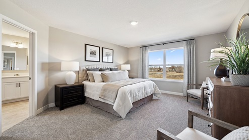 Bedroom suite with dual walk in closets and private bathroom.