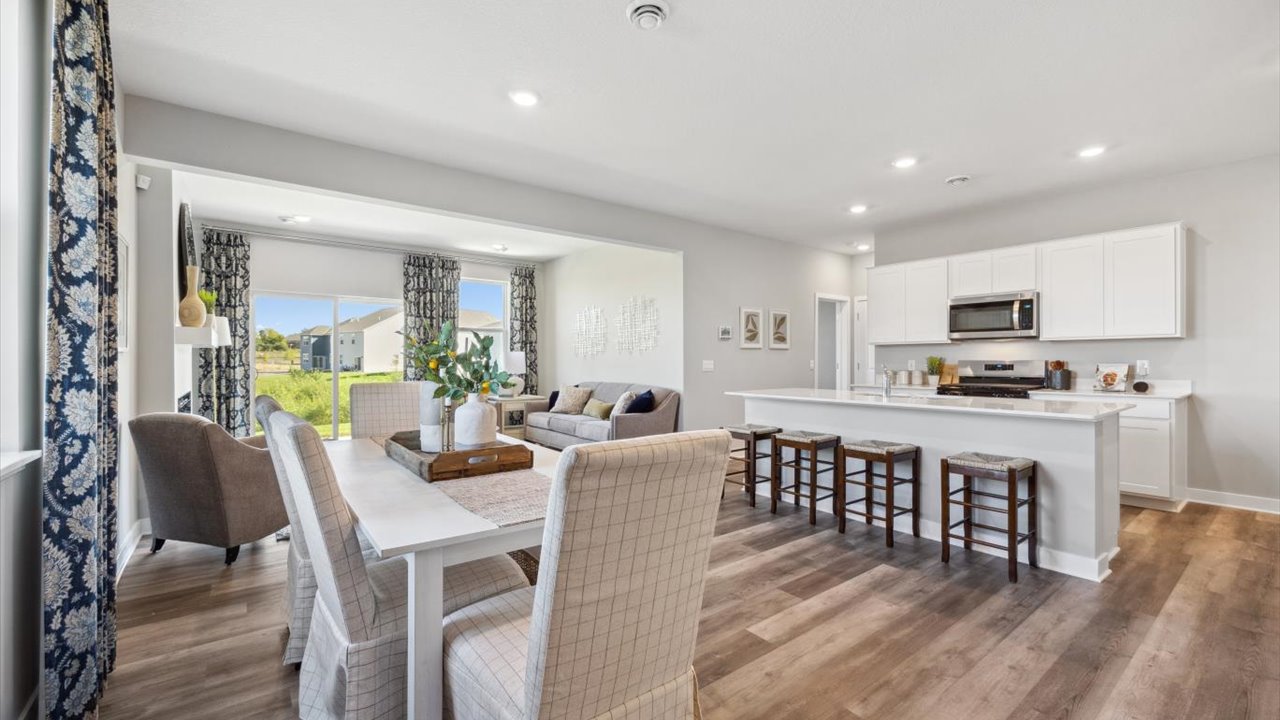 Open concept main level with living, kitchen, and dinette areas.
