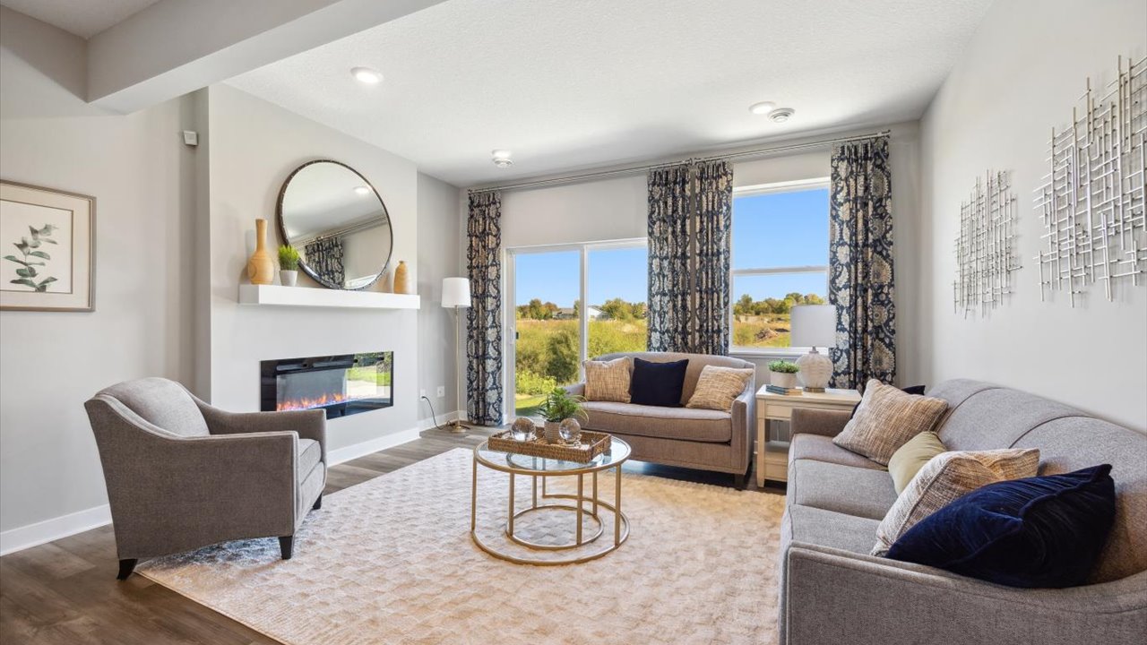 Living room with hard flooring and electric fireplace.