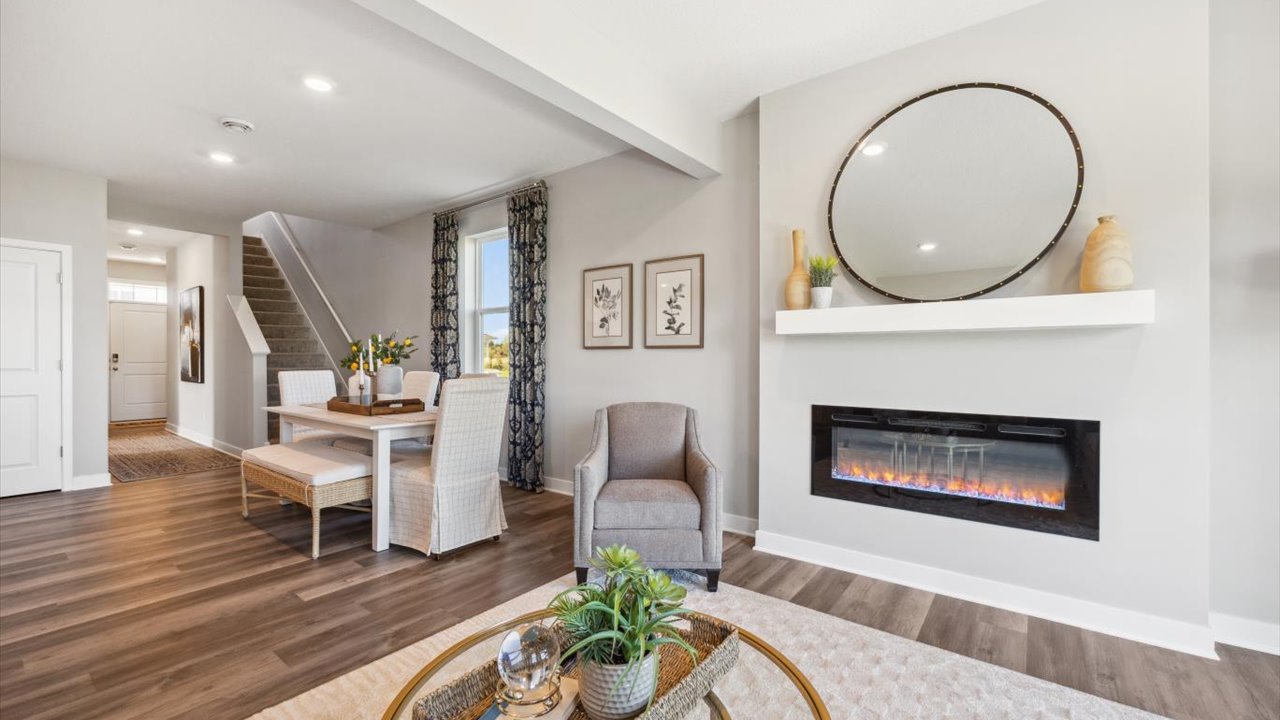 Electric fireplace in living room adjacent to dinette area.