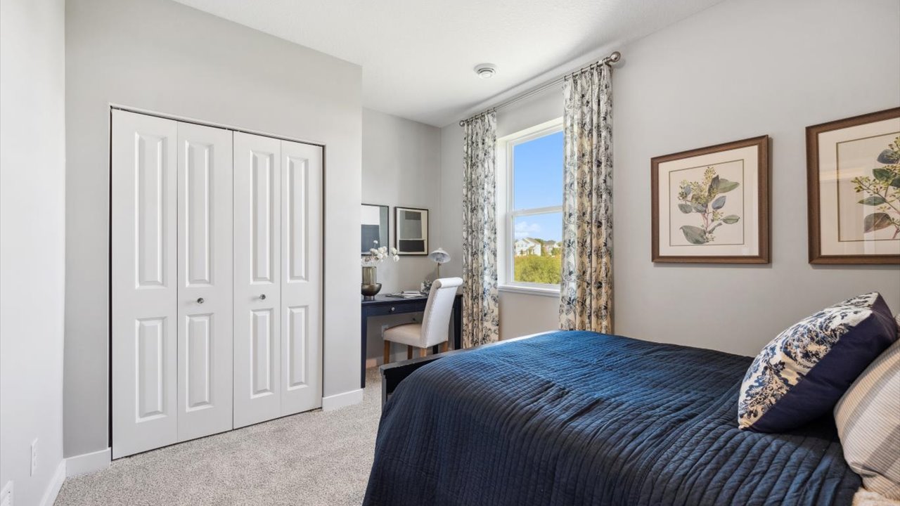 Carpeted main level bedroom with standard closet.