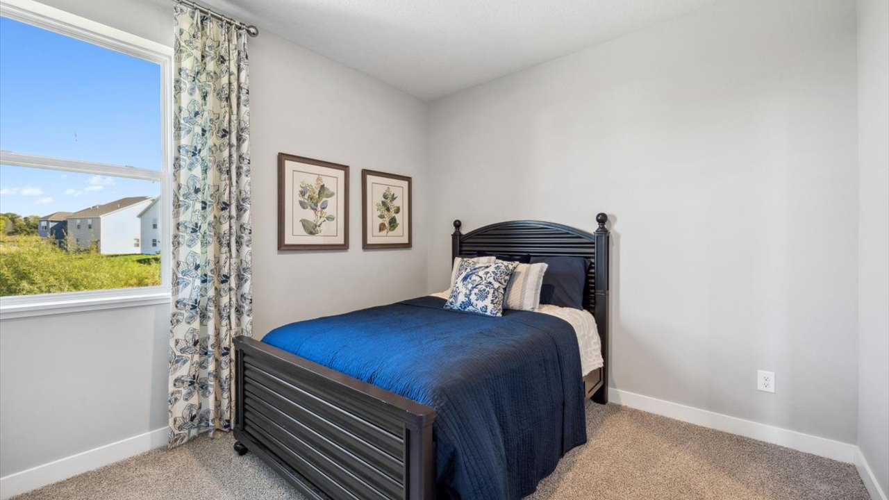 Carpeted main level bedroom with standard closet.